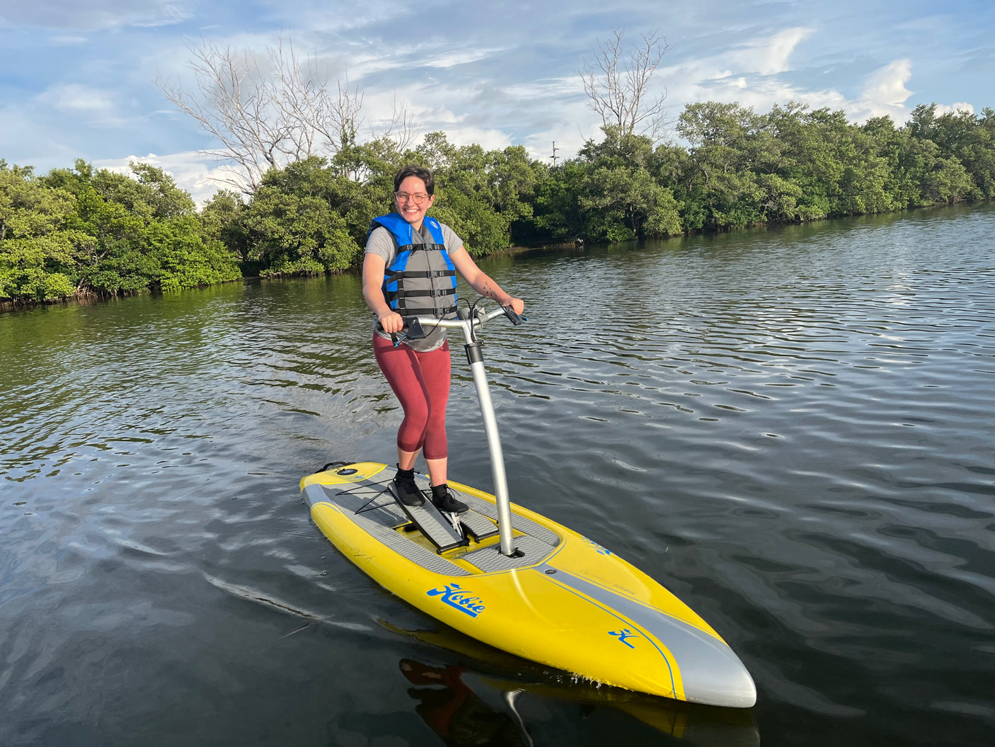 Person on a Hobie Mirage Eclipse pedal board in calm waters. Ideal water fun during your RV rental vacation!
