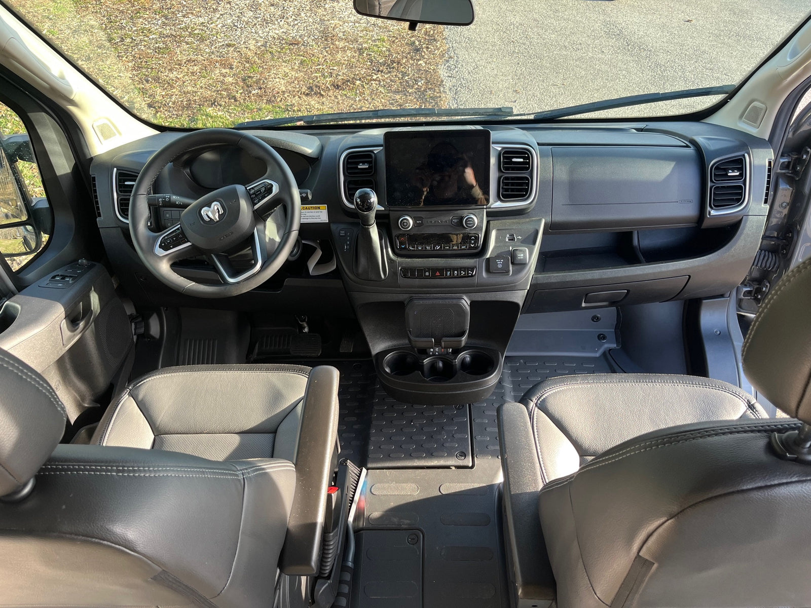 Spacious RV rental cockpit with modern dashboard, large infotainment screen, and comfortable seating, ideal for road trips.