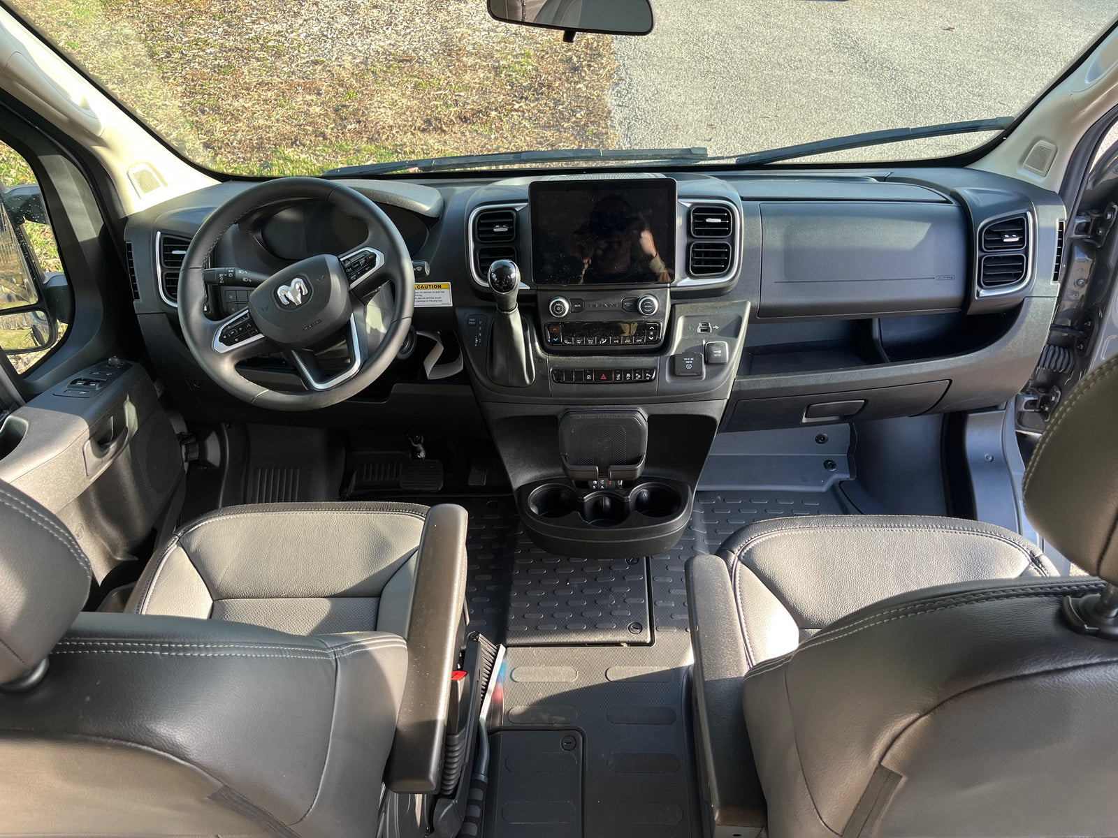 Spacious RV rental cockpit with modern dashboard, large infotainment screen, and comfortable seating, ideal for road trips.