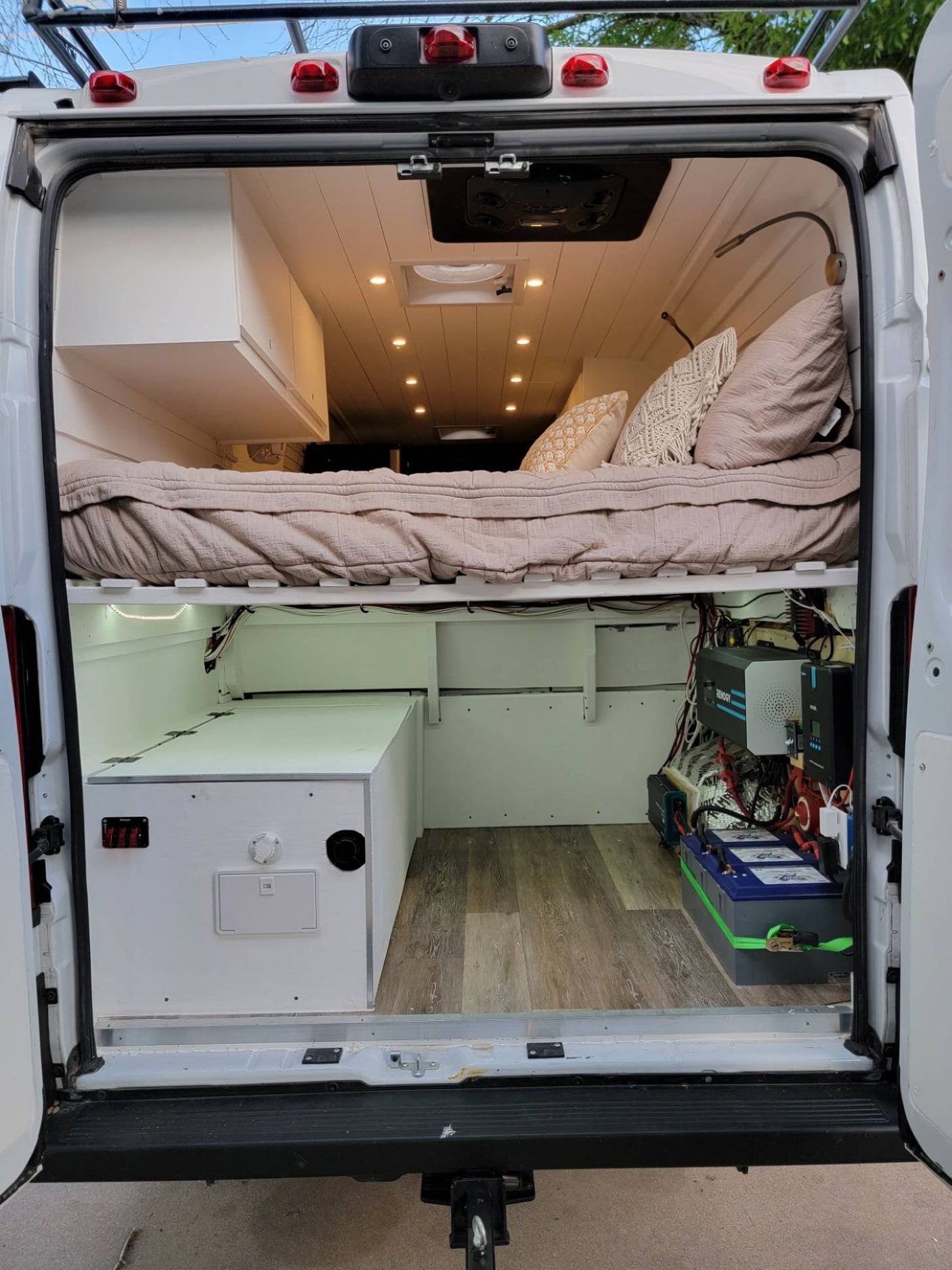 RV rental camper van interior: elevated bed, storage, and detailed electrical system ready for adventures.