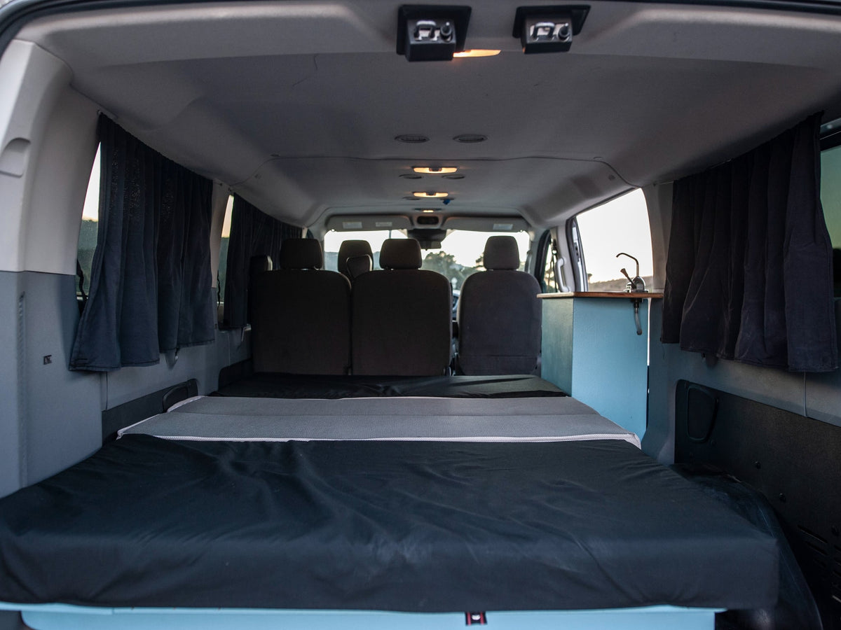 and a queen-size bed for comfortable van life.|Queen size bed inside this spacious RV rental campervan — photo 20
