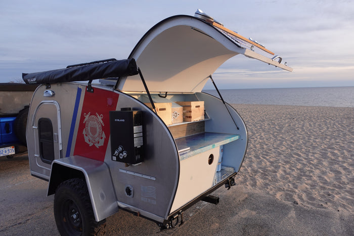 Experience unique beach camping with this compact RV rental! Teardrop camper features an open outdoor kitchen.