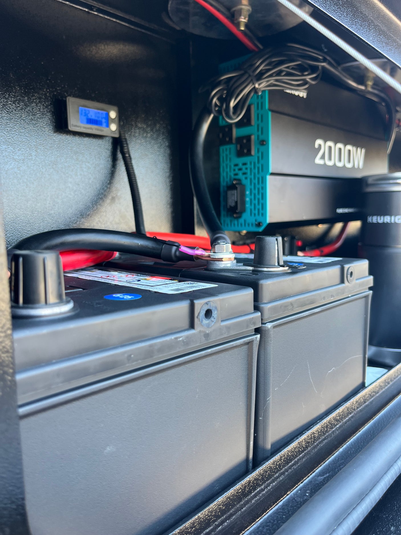 RV rental power setup: 2000W inverter, dual batteries, and voltage display. Essential for off-grid adventures.
