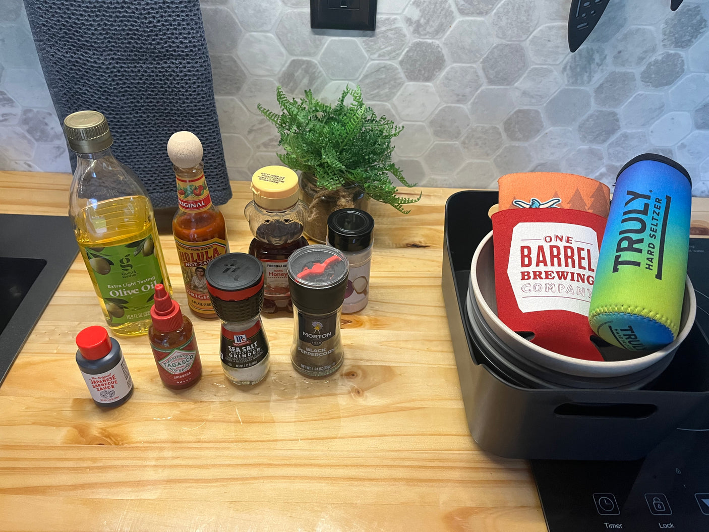 RV rental kitchen essentials: olive oil, hot sauce, spices, and honey, ready for convenient meals on the go.