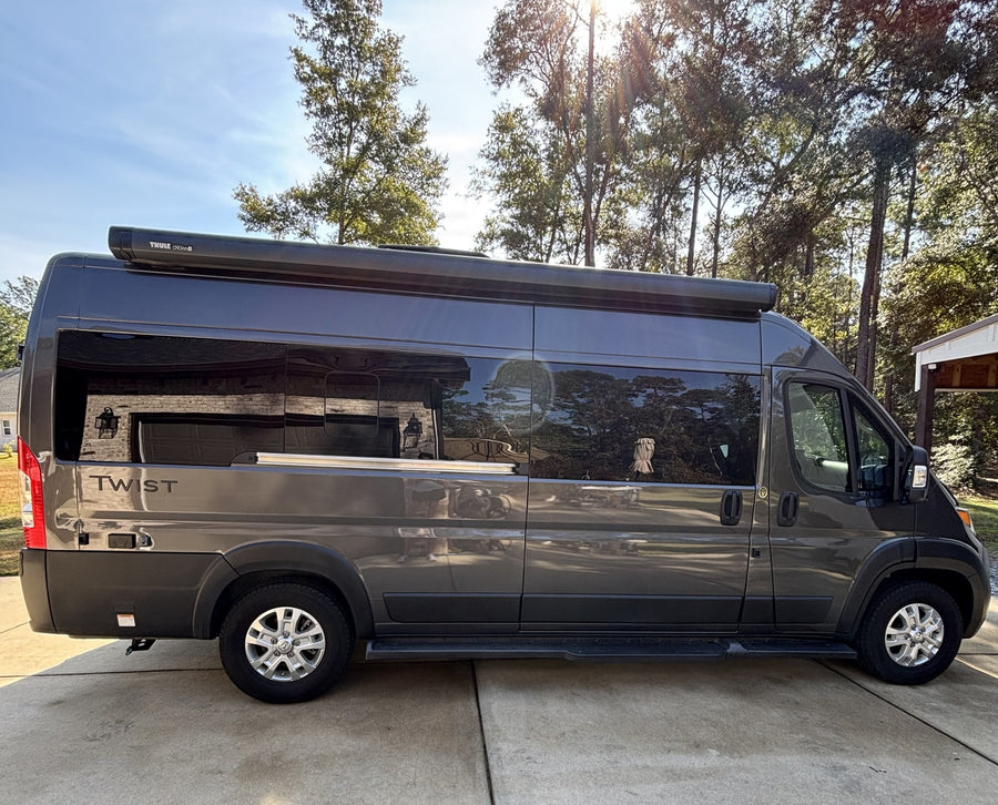 Dark gray camper van with a Thule awning