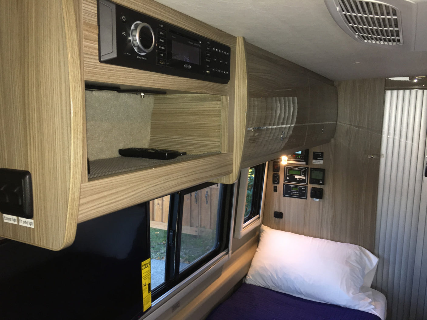 ideal for mobile living.|Compact RV rental interior featuring a kitchen with sink & covered stovetop