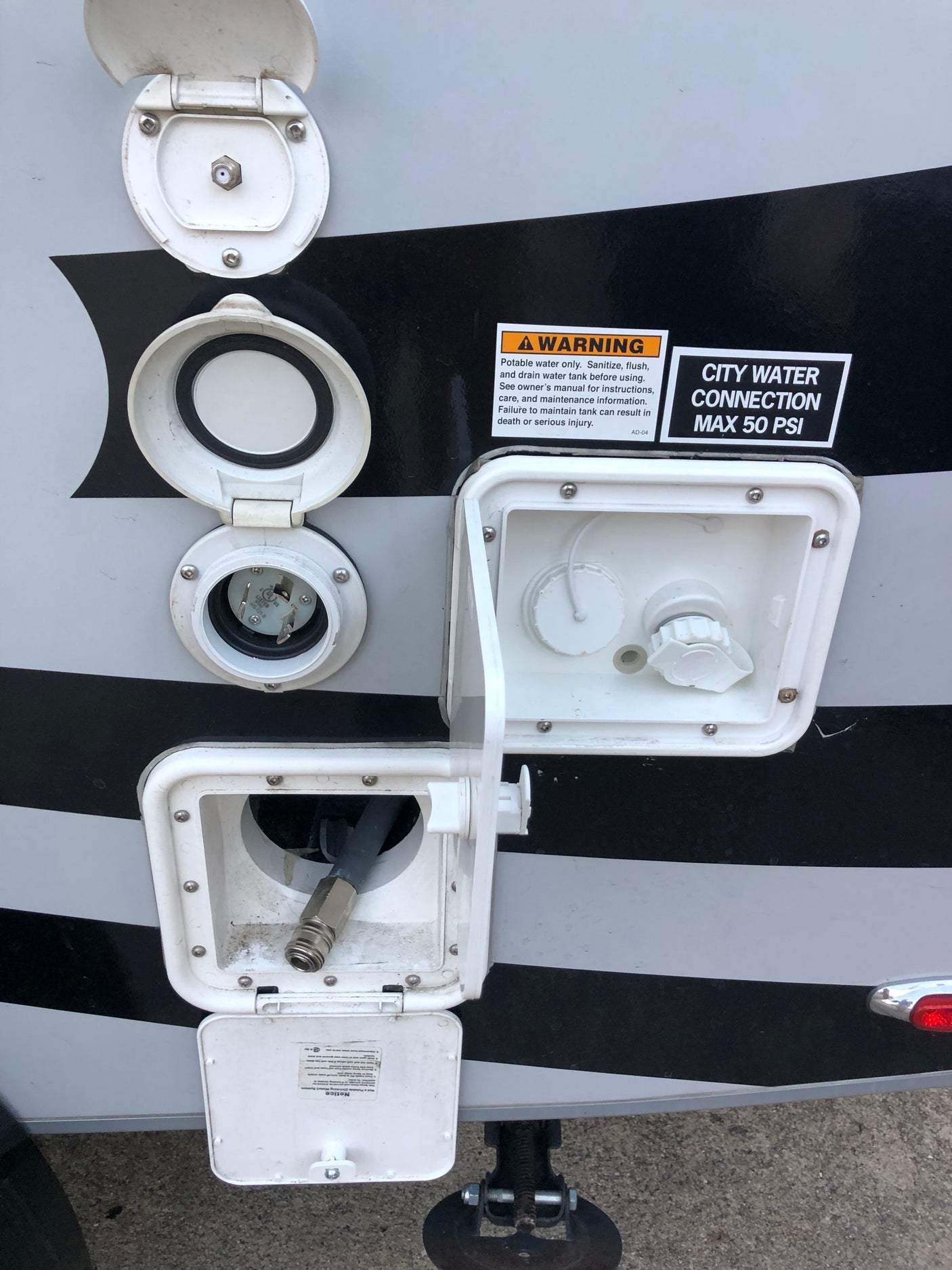 RV rental external connections: water hookup (max 50 PSI), electric shore power, cable, and quick-connect hose.