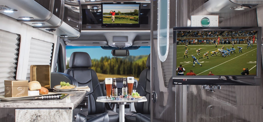 and sleek dark wood interior.|Relax in style with this RV rental's black leather sofa
