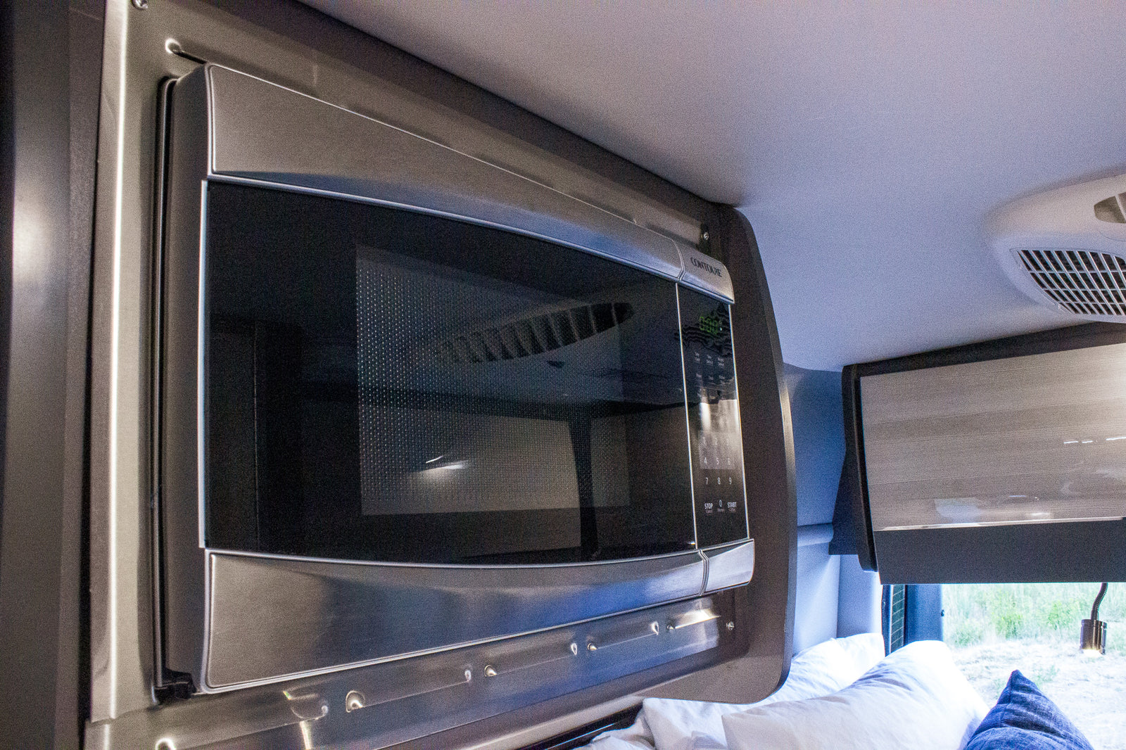 RV rental interior: Built-in microwave for easy meal prep on your journey.