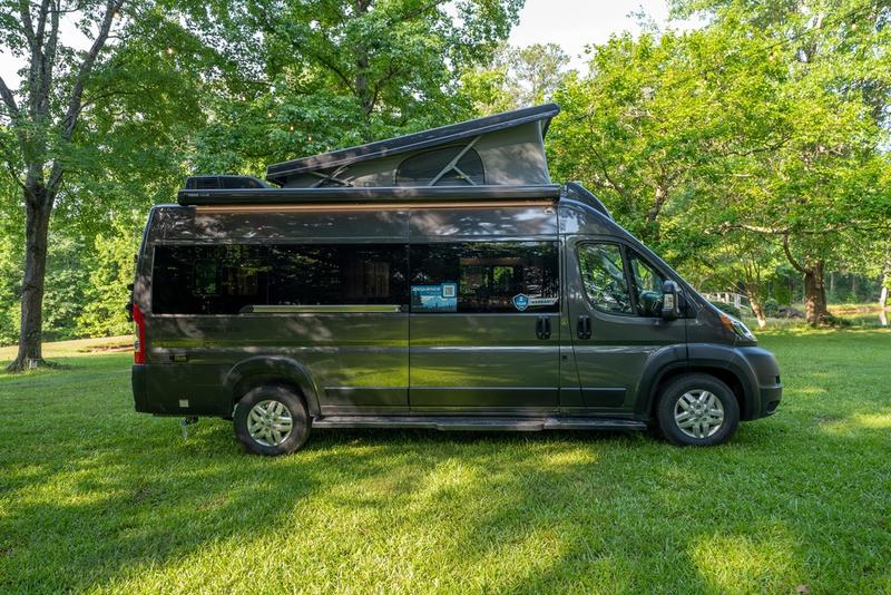 and mirror for essential comfort.|U-shaped dinette inside a modern RV rental: light cushions