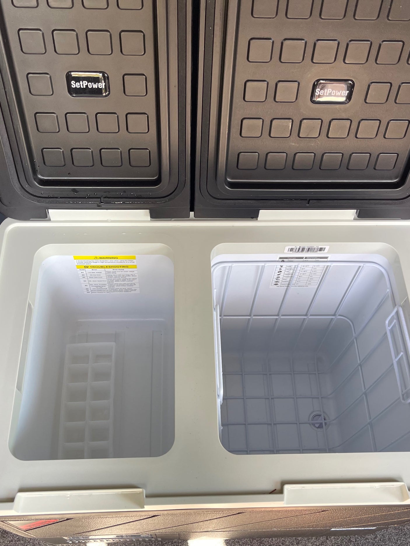 Open SetPower dual-zone portable fridge/freezer, ideal for rv rental trips. Features separate compartments & ice tray.