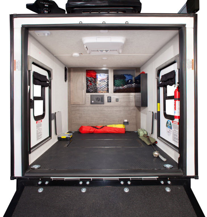 Spacious RV rental toy hauler interior. Features durable floor, side doors, storage, and AC. Perfect for hauling adventure gear.