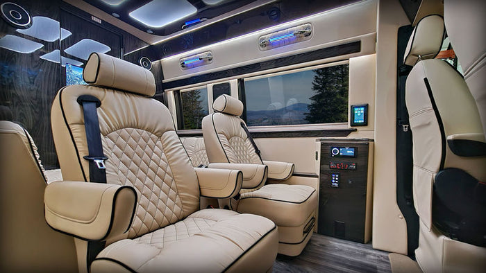 and modern design.|Luxurious RV rental interior: cream captain's chairs