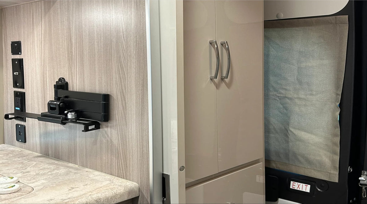 plus a peek at the bathroom.|A built-in stainless steel mini-fridge under a light-colored counter in an RV rental — photo 12