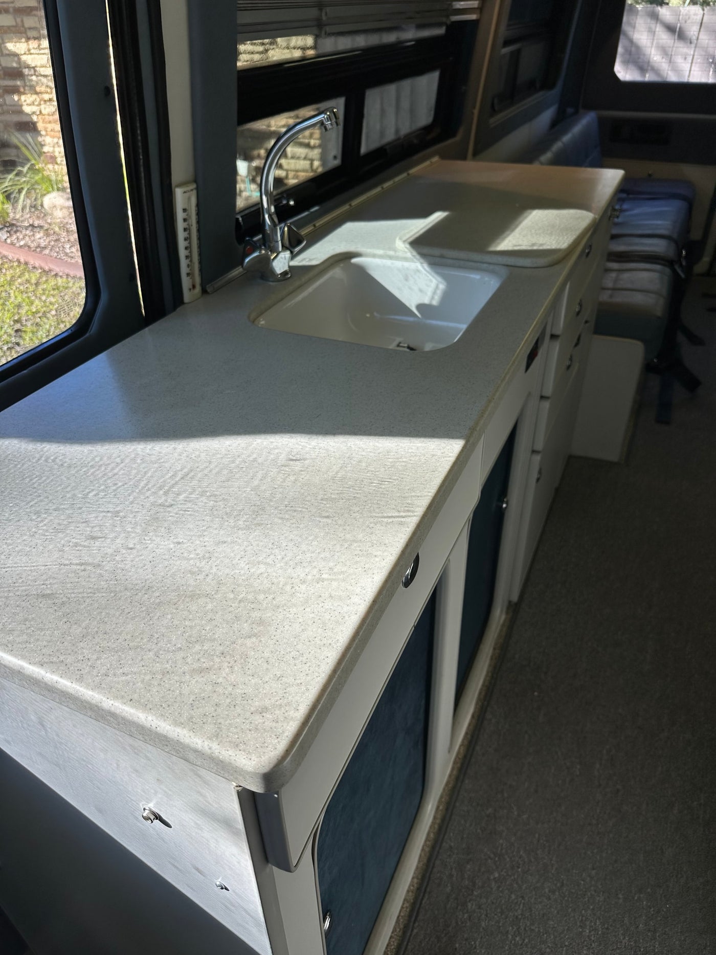 and overhead cabinets.|Compact RV rental kitchen with a counter — photo 7
