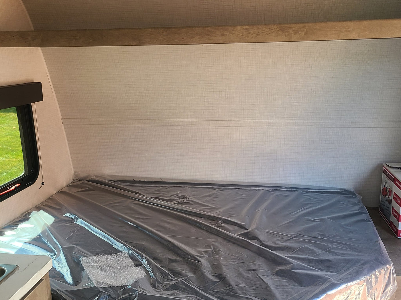next to a cozy bunk bed.|Grey mattress on a built-in bunk bed in an RV rental — photo 6