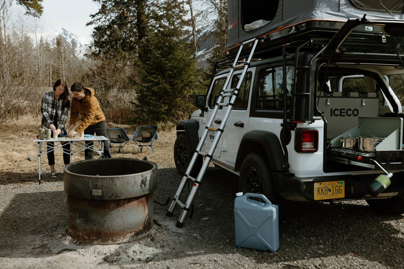 Prepping a meal on an RV rental overlanding Jeep with a roof top tent in Alaska. Perfect for outdoor adventure.