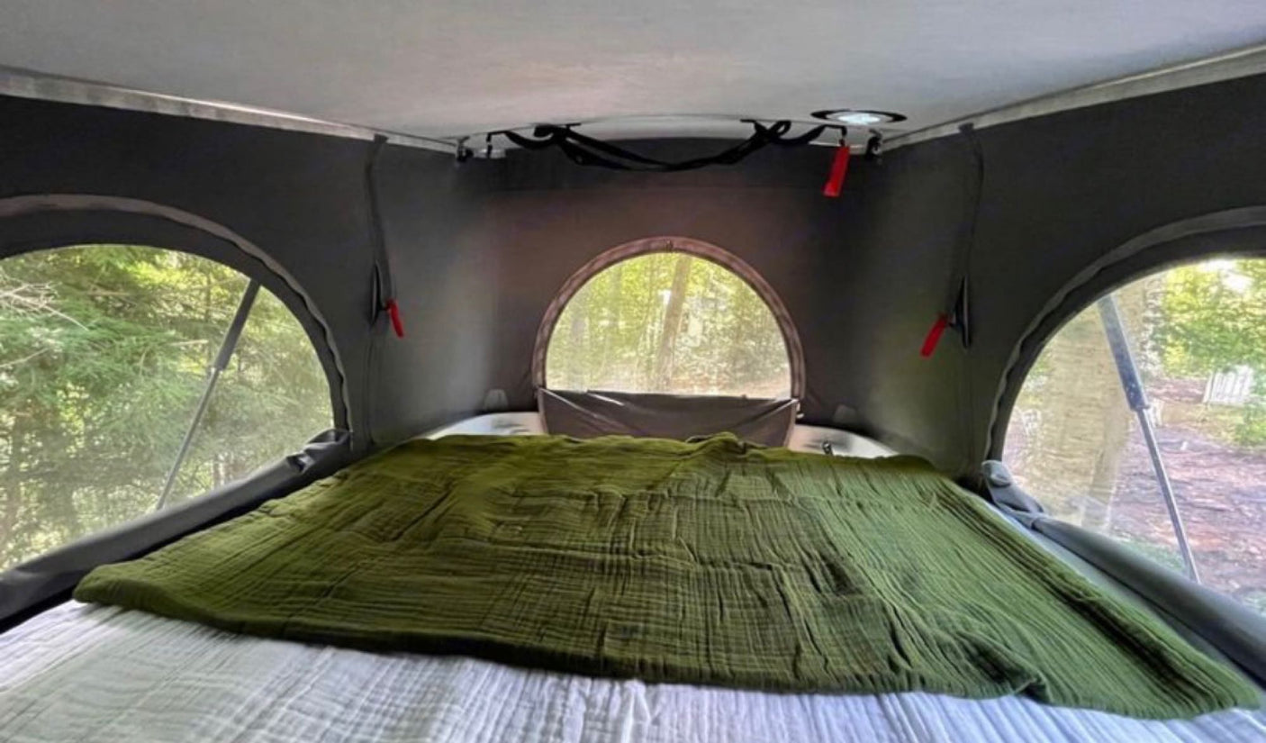 Experience nature with this RV rental! This pop-top tent bedroom has a comfy bed & forest views from mesh windows.