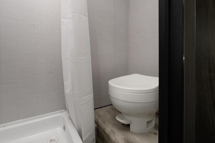 and compact fridge.|Cozy RV rental interior shows kitchenette