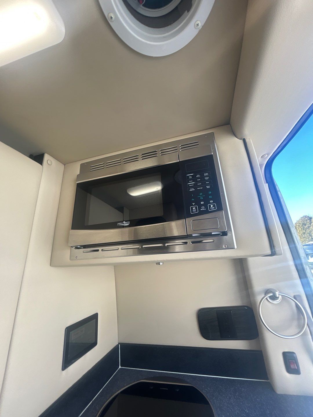 and bright accent lights.|Luxury RV rental interior featuring cream quilted captain's chairs