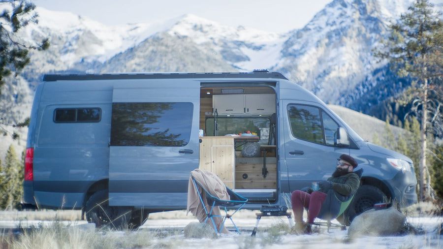 and cozy bed setup.|RV rental van interior with front seats
