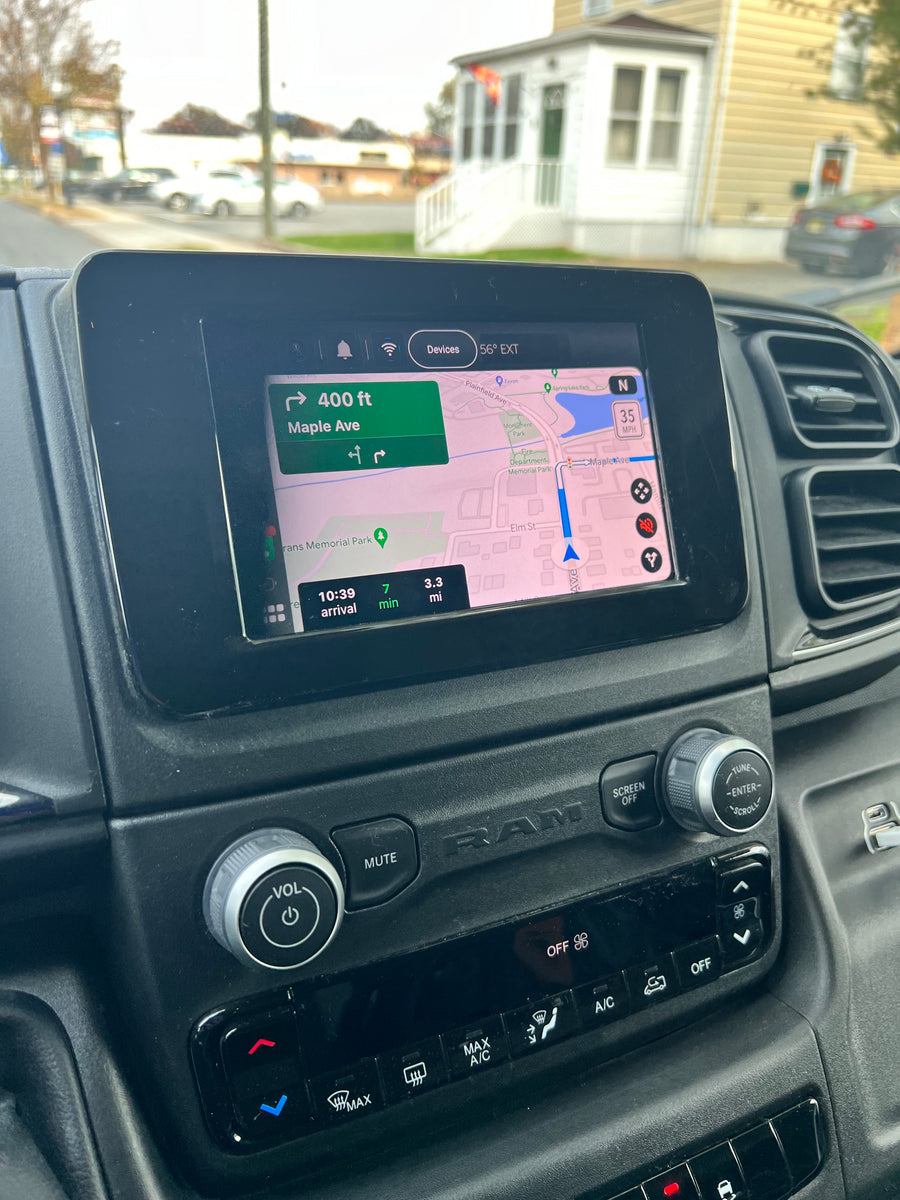 Inside an RV rental van: navigation display showing a map, next turn, and arrival details on the dashboard.
