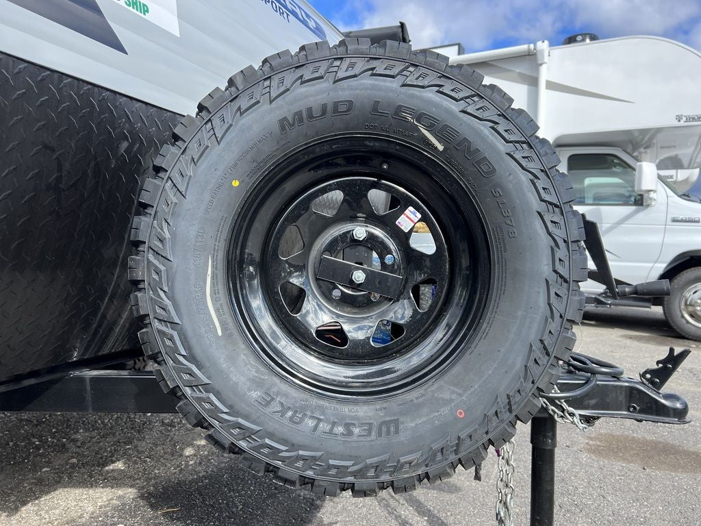 features off-road tires and a front spare.|Close-up of a rugged Westlake Mud Legend tire on an RV rental