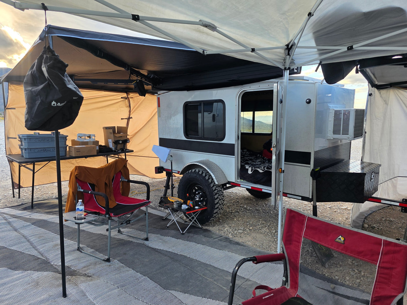and solar panels in a remote desert landscape.|An RV rental camping site with a silver teardrop trailer — photo 3