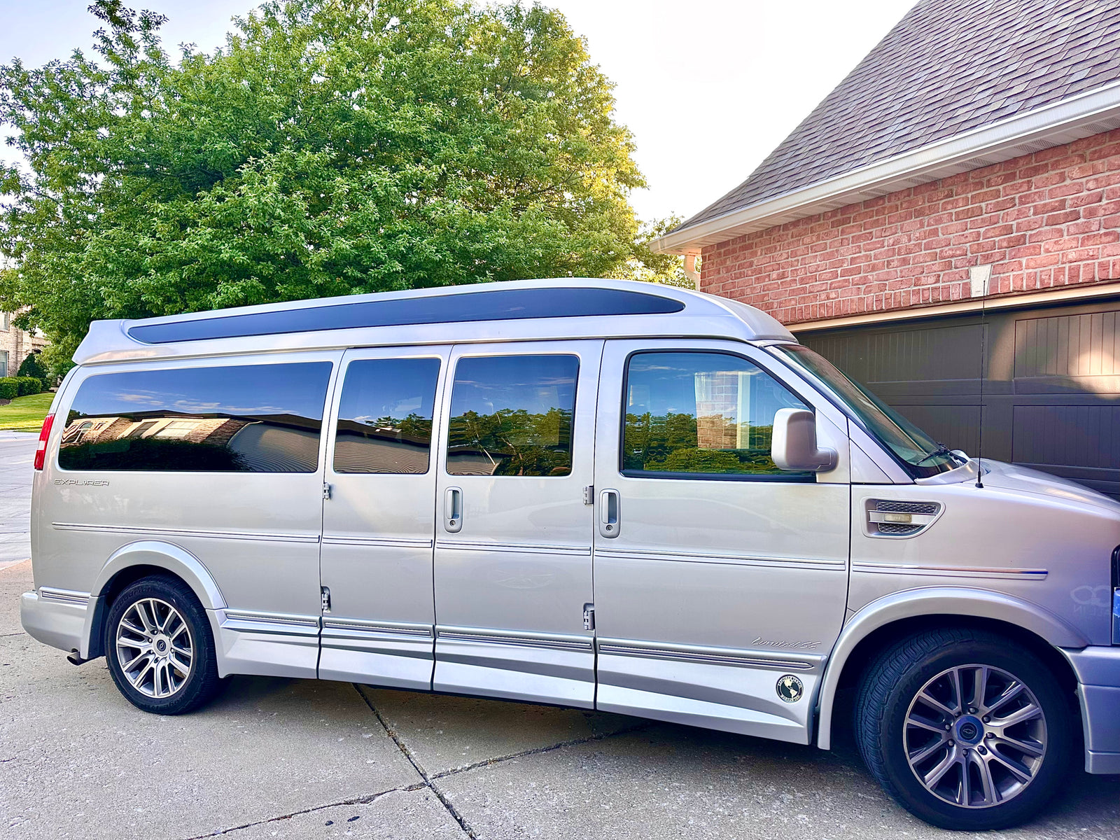 ready for your next rv rental trip. Parked on a driveway.|Silver Explorer conversion van