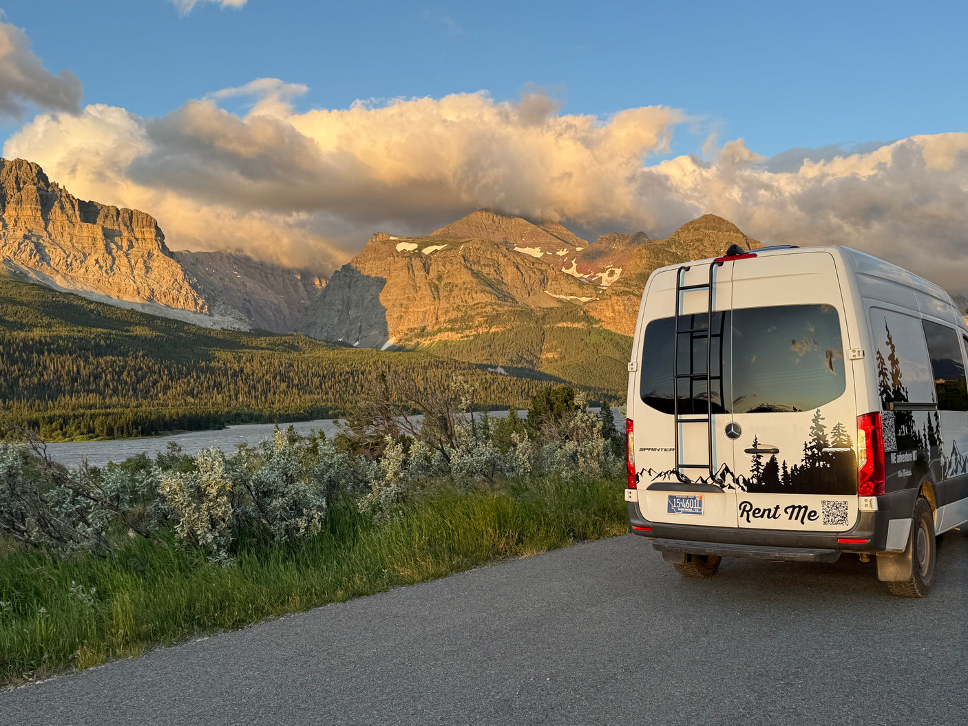 White Mercedes Sprinter rv rental van overlooking scenic mountains, lake, & forest at golden hour.