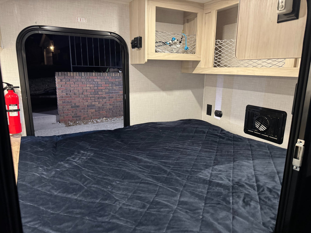 is ready for mountain adventures under a sunset sky.|Cozy RV rental interior with a bed — photo 6