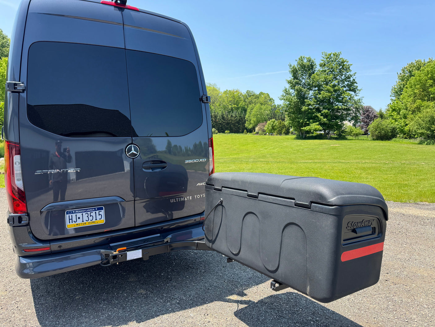 This Mercedes Sprinter RV rental, an Ultimate Toys motor home, features a StowAway cargo box on its rear hitch.