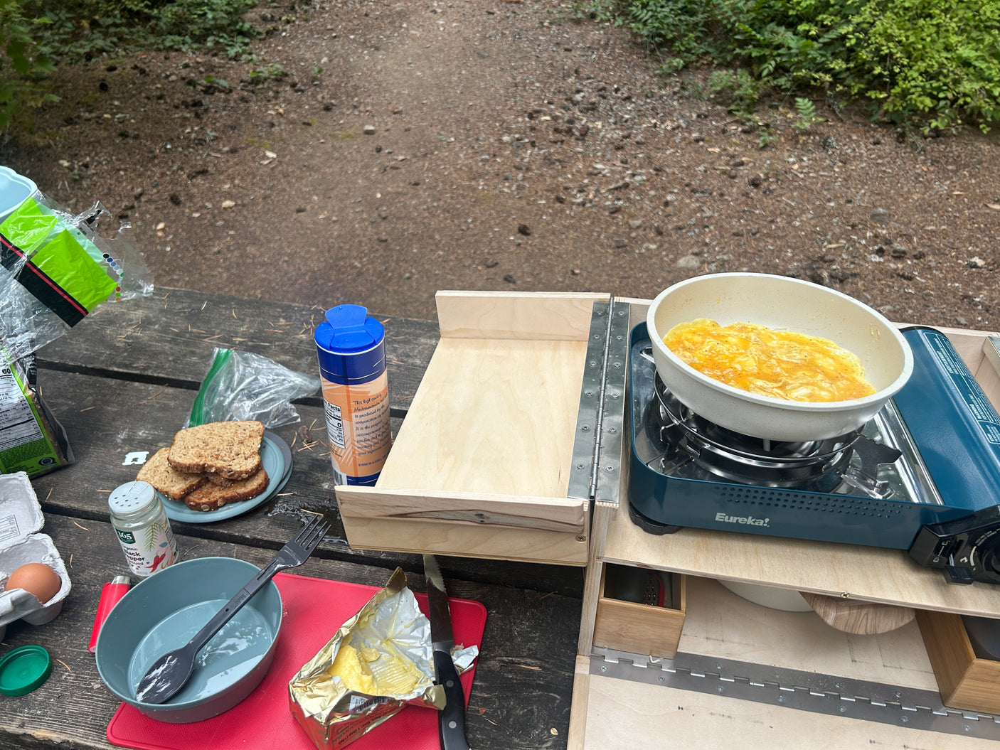 Enjoying a fresh camping breakfast with eggs and toast using a portable stove, perfect for your rv rental adventure.