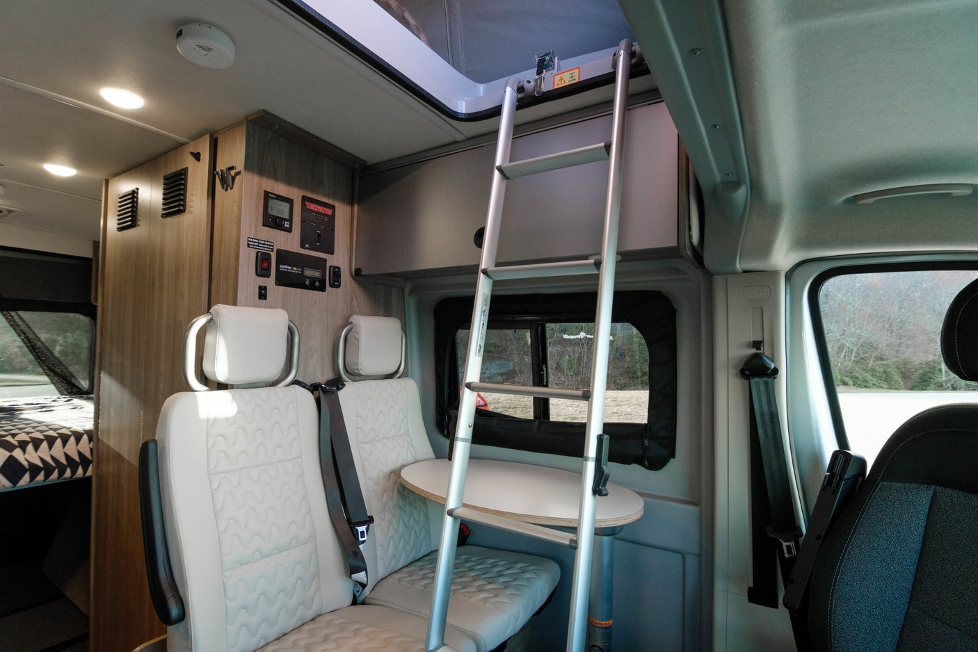 and ample lighting for comfortable living.|Spacious rv rental interior featuring a kitchen