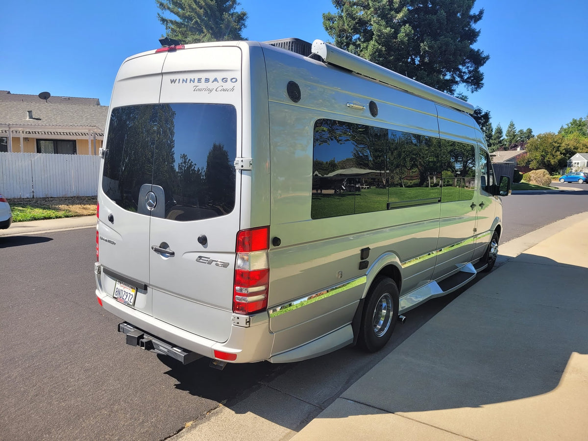 ready for your next adventure. Consider this sleek rv rental for memorable road trips and camping.|Silver Winnebago Sprinter rv rental van parked on a sunny street — photo 5