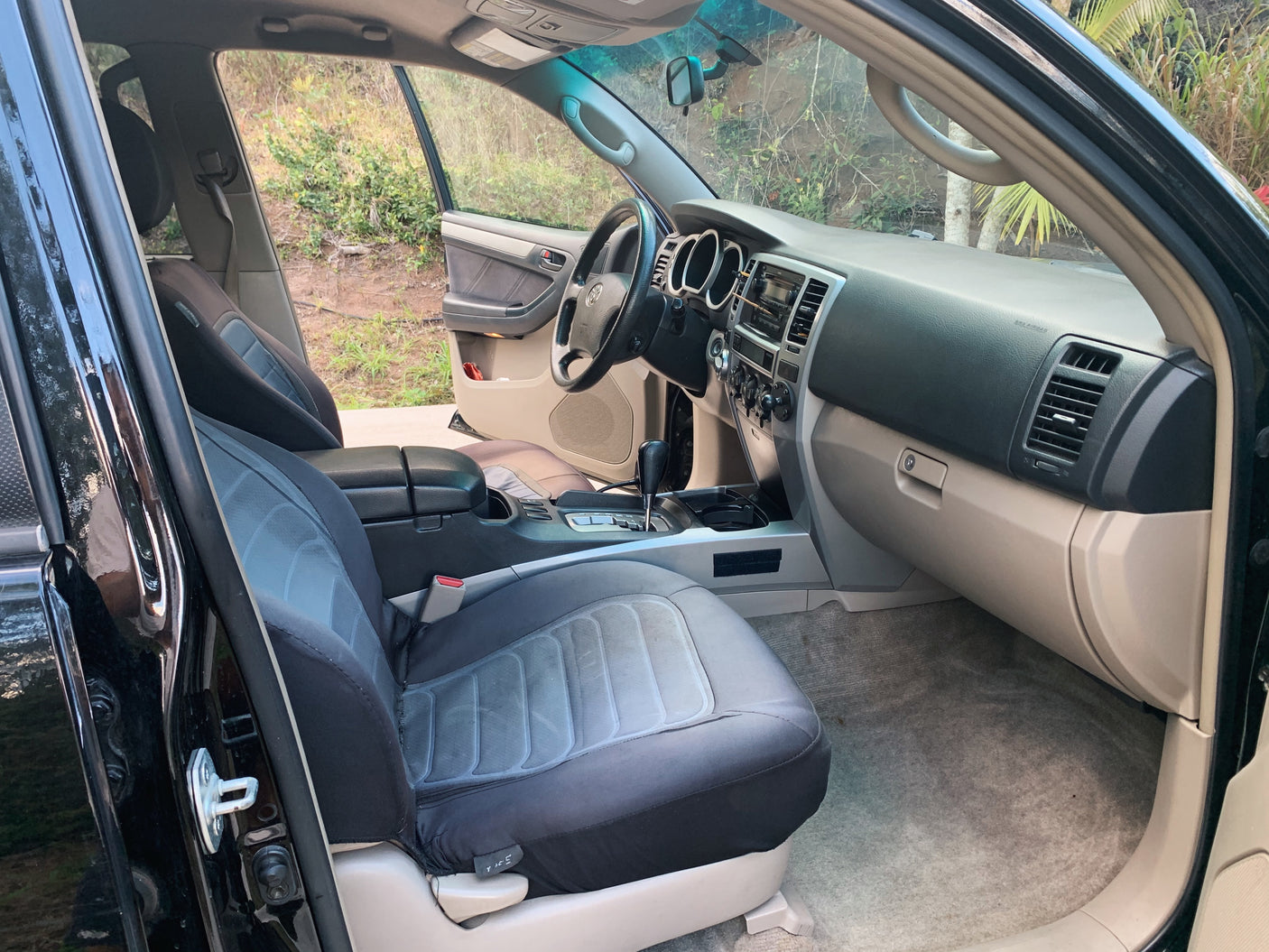 Comfortable SUV interior, perfect for road trips or as part of an RV rental package. Shows front seats, dash, and console.