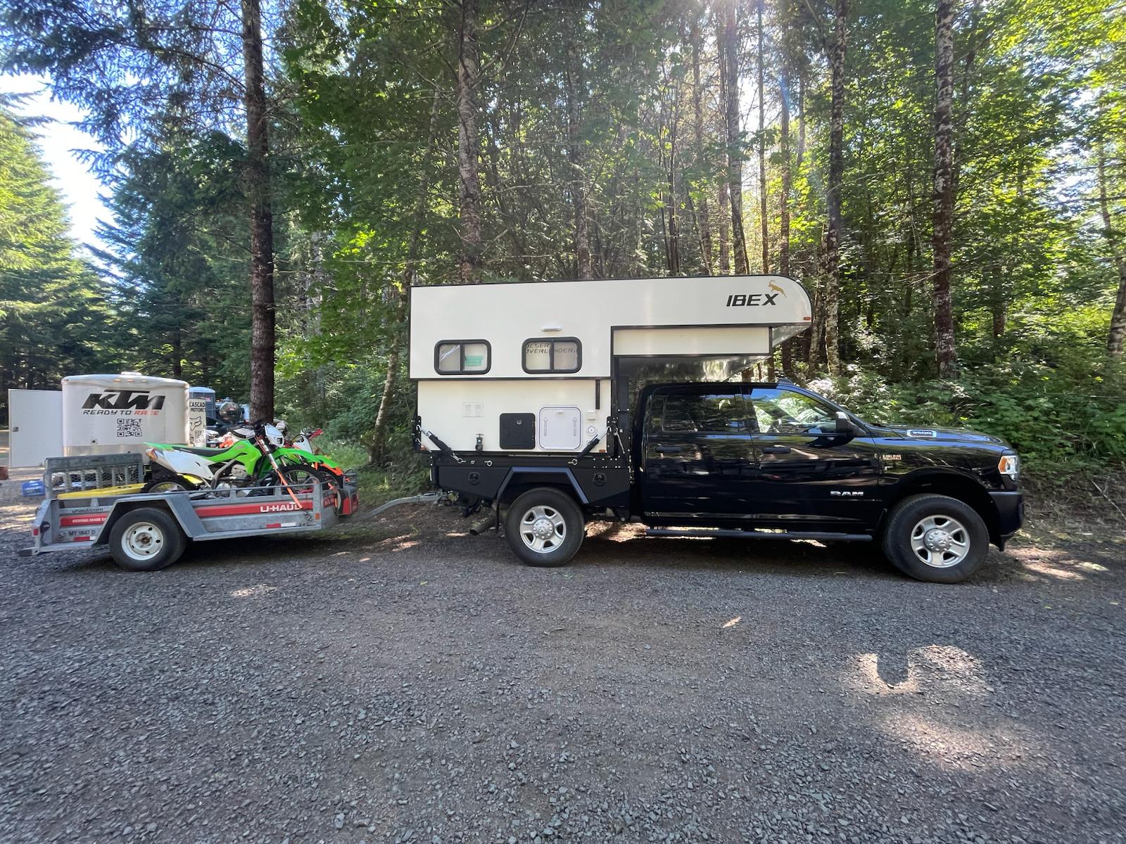 and a dining table.|Black Ram 3500 truck with an Ibex camper