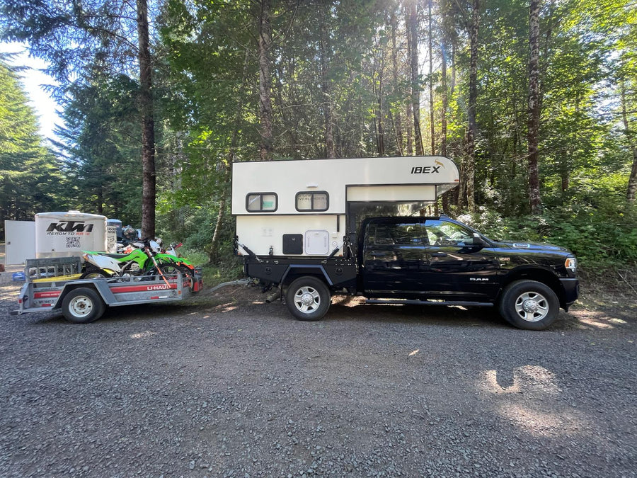and a dining table.|Black Ram 3500 truck with an Ibex camper