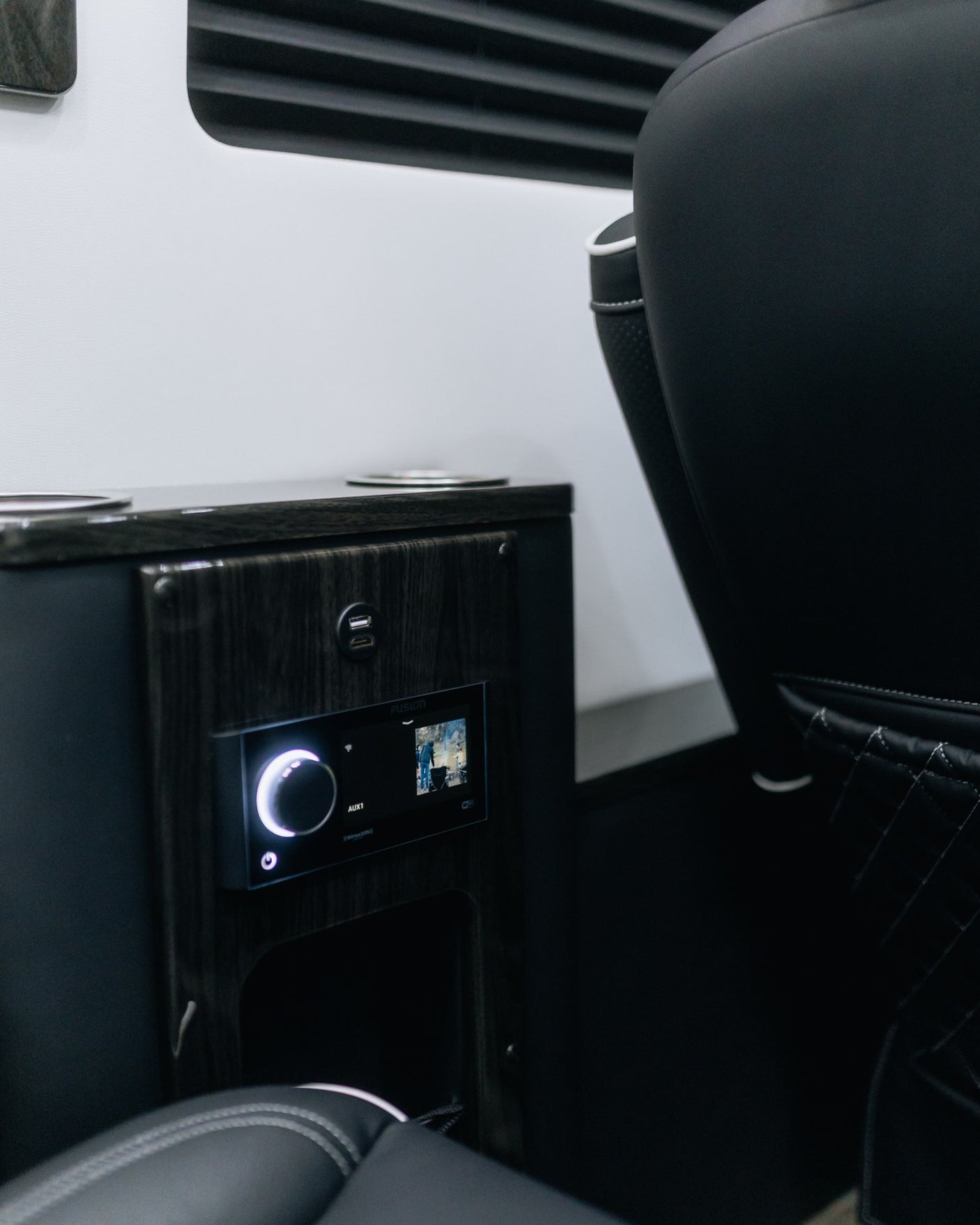 Experience premium comfort in this RV rental. Interior features include plush seating & a modern infotainment panel with USB charging.