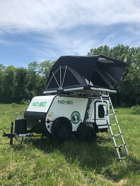 Get ready for adventure! This NO.BO travel trailer with a rooftop tent is perfect for your next rv rental camping trip.|Travel trailer RV rental features an outdoor kitchen with stovetop & fridge