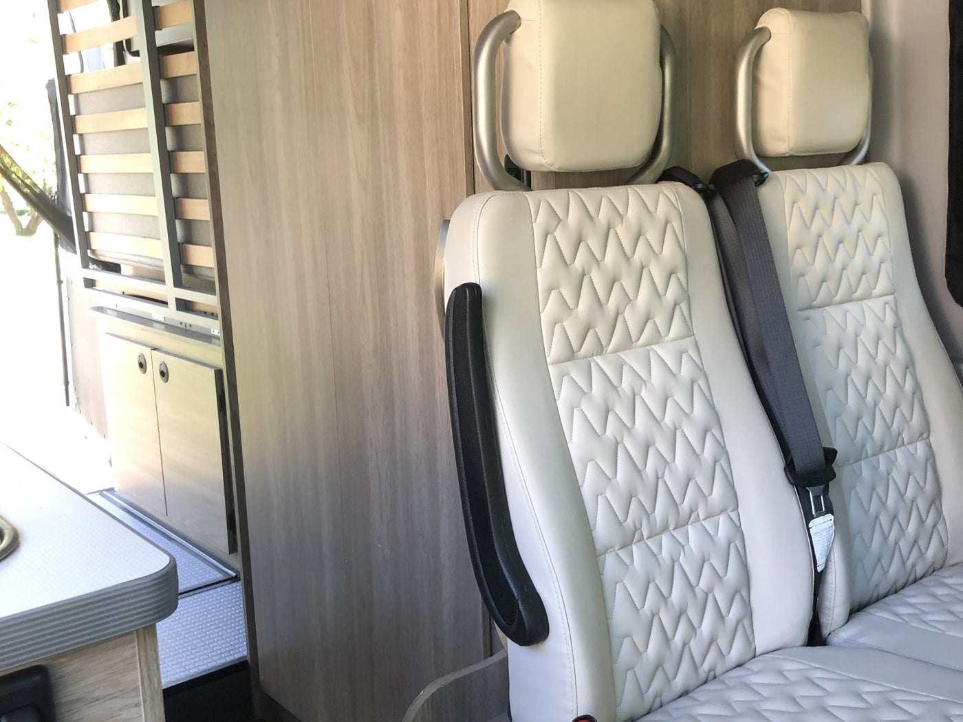 and slatted bed frame. Ready for adventure.|View inside an RV rental showing a kitchen with stove/sink — photo 9