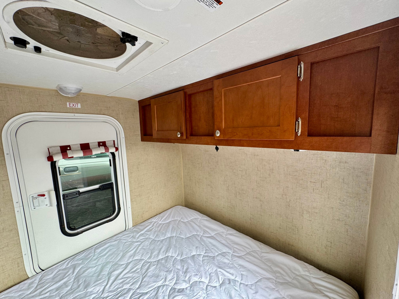 door open to a comfy interior bed. Ideal for road trip adventures.|Cozy RV rental interior: large bed — photo 5