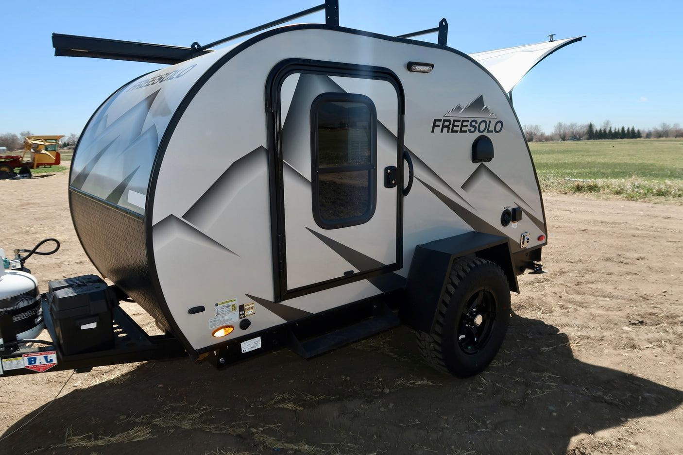 This Freesolo compact camper trailer, ideal for RV rental, features an off-road design, front window & roof rack.