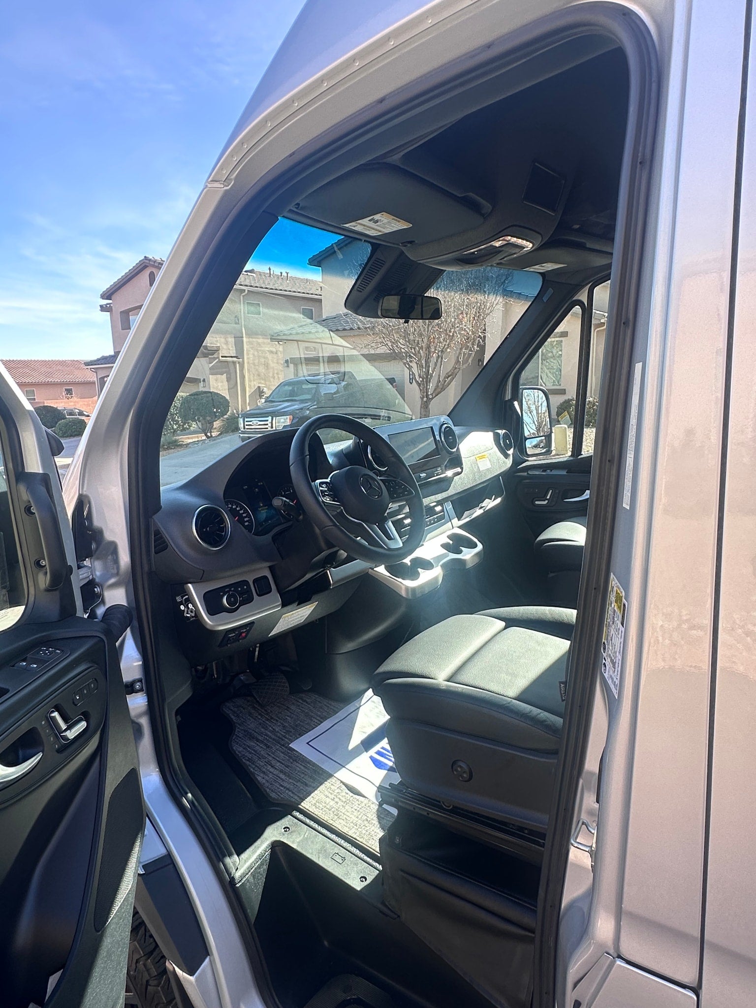 ready for adventure.|Rear view of a sleek silver Thor Sanctuary Mercedes-Benz camper van