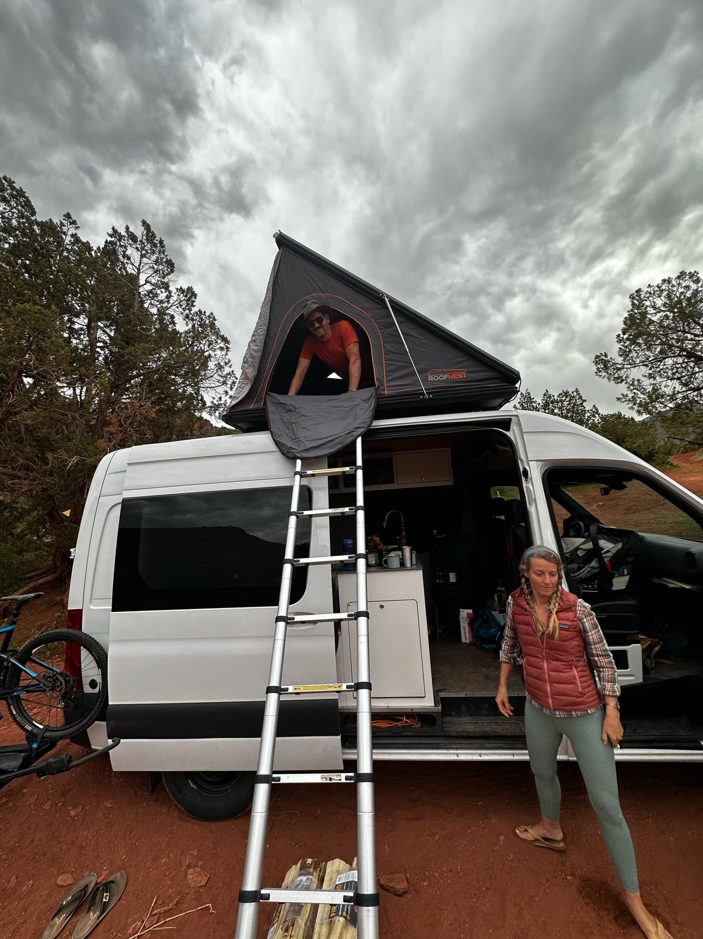 and Webasto heater. Red bench and storage.|Overhead cabinets open in a cozy RV rental — photo 17