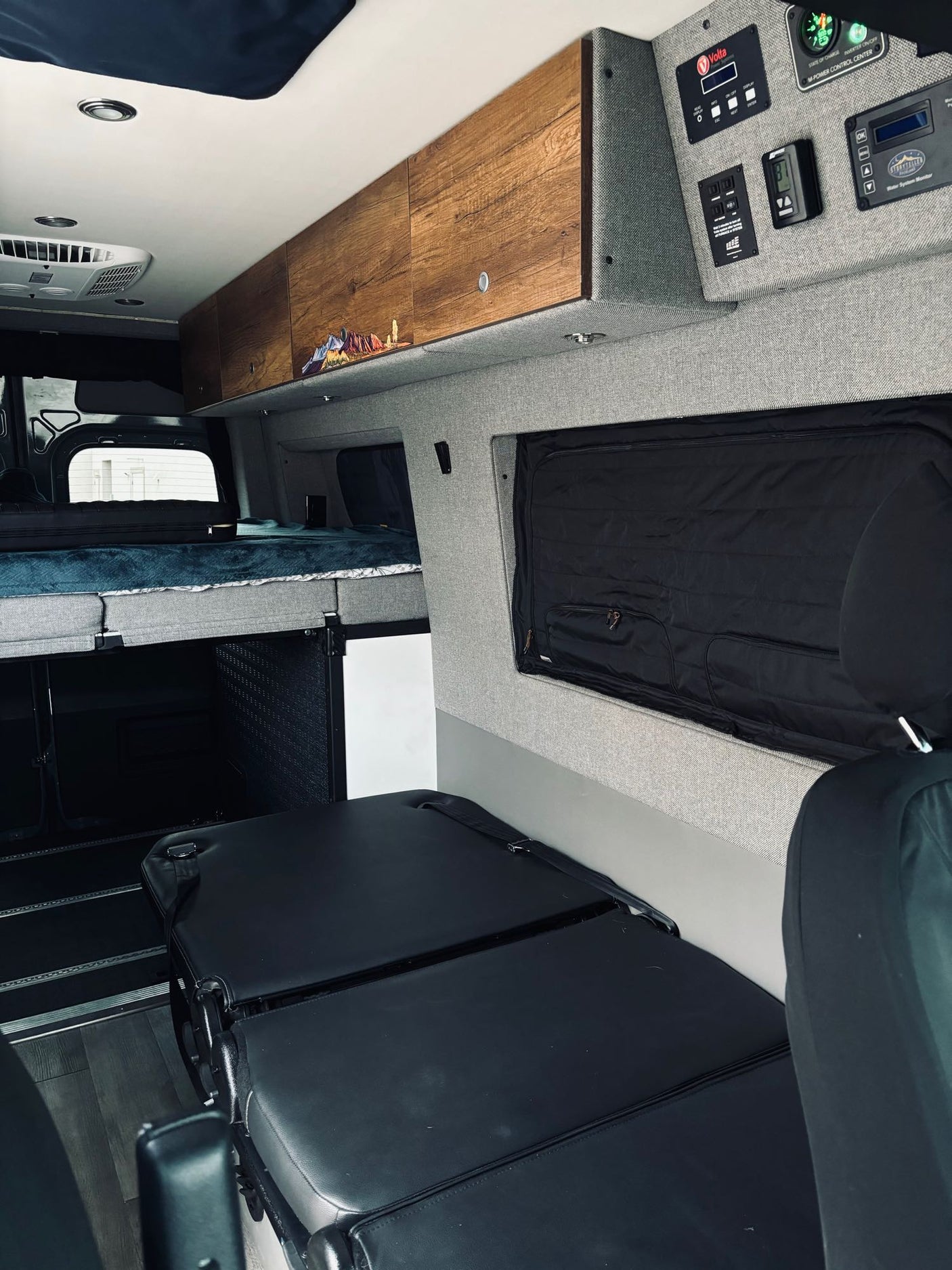 RV rental interior featuring a cozy bed, ample storage, and advanced power controls for a comfortable journey.