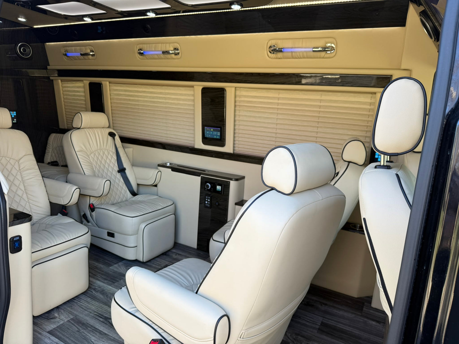 ideal for an RV rental.|Luxurious RV rental interior with plush cream leather seating