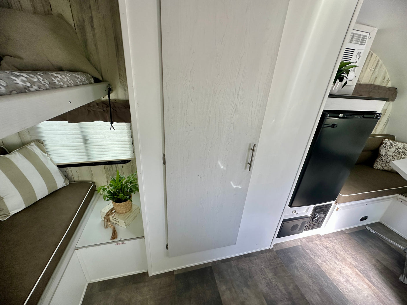 and drain. Light wood-look walls and ceiling vent visible.|RV rental interior featuring a compact kitchen