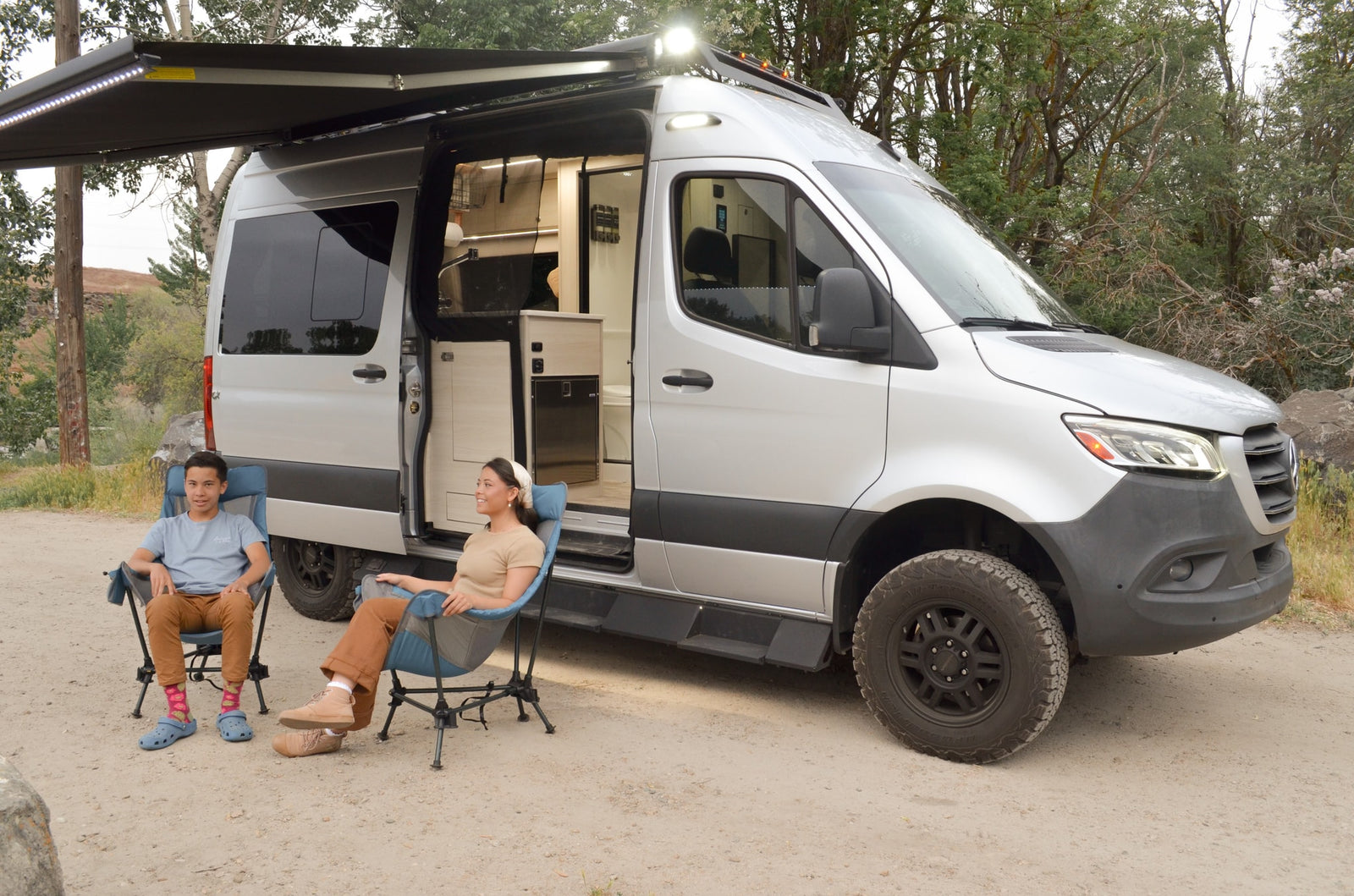 offering a glimpse into the connected cozy bedroom.|Inside this cozy rv rental: comfortable benches