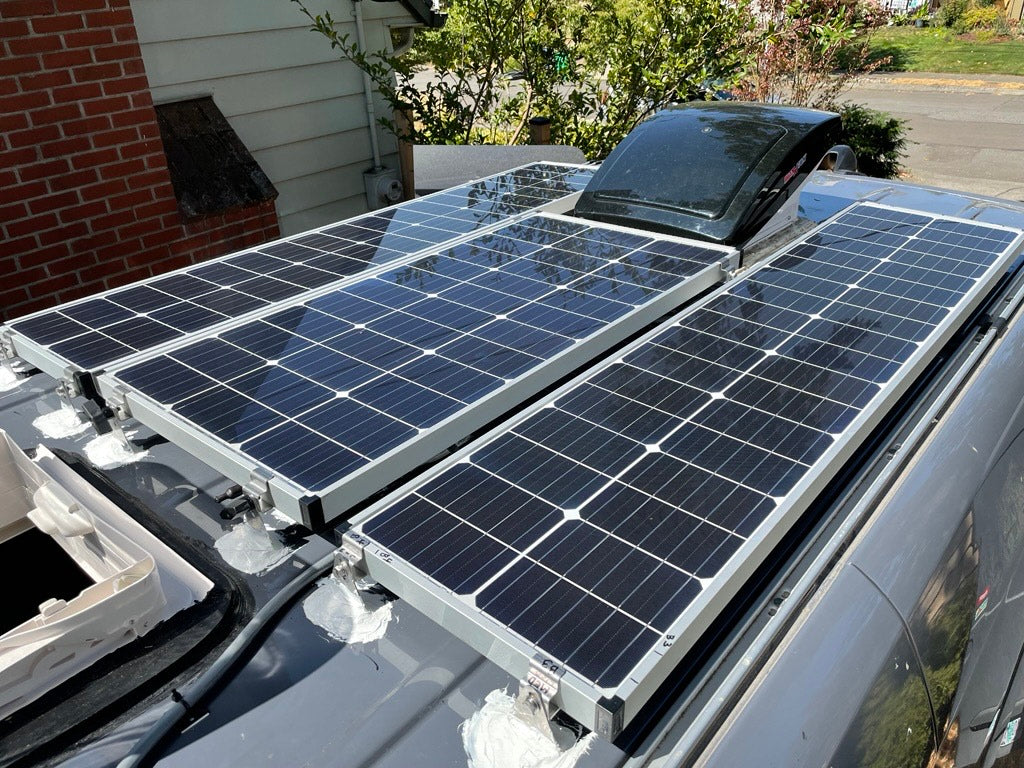 Rooftop solar panels & vent on an RV rental van, providing off-grid power.